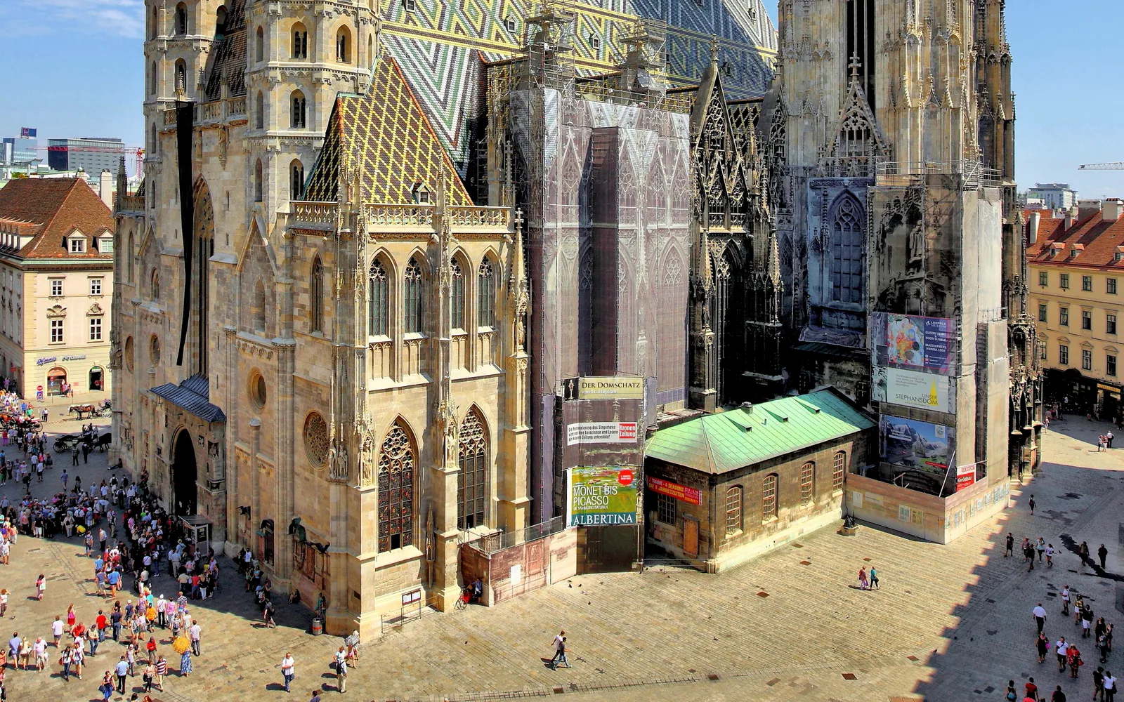 St. Stephen's Cathedral in Vienna, its roof tiled in a brightly coloured checkerboard mosaic, the 136-metre Gothic tower rising into a clear blue sky