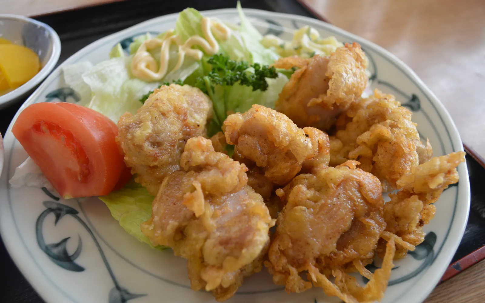 โทริเท็นไก่ทอดชุบแป้งสีทอง เสิร์ฟพร้อมน้ำจิ้มปอนสึบนจานขาว