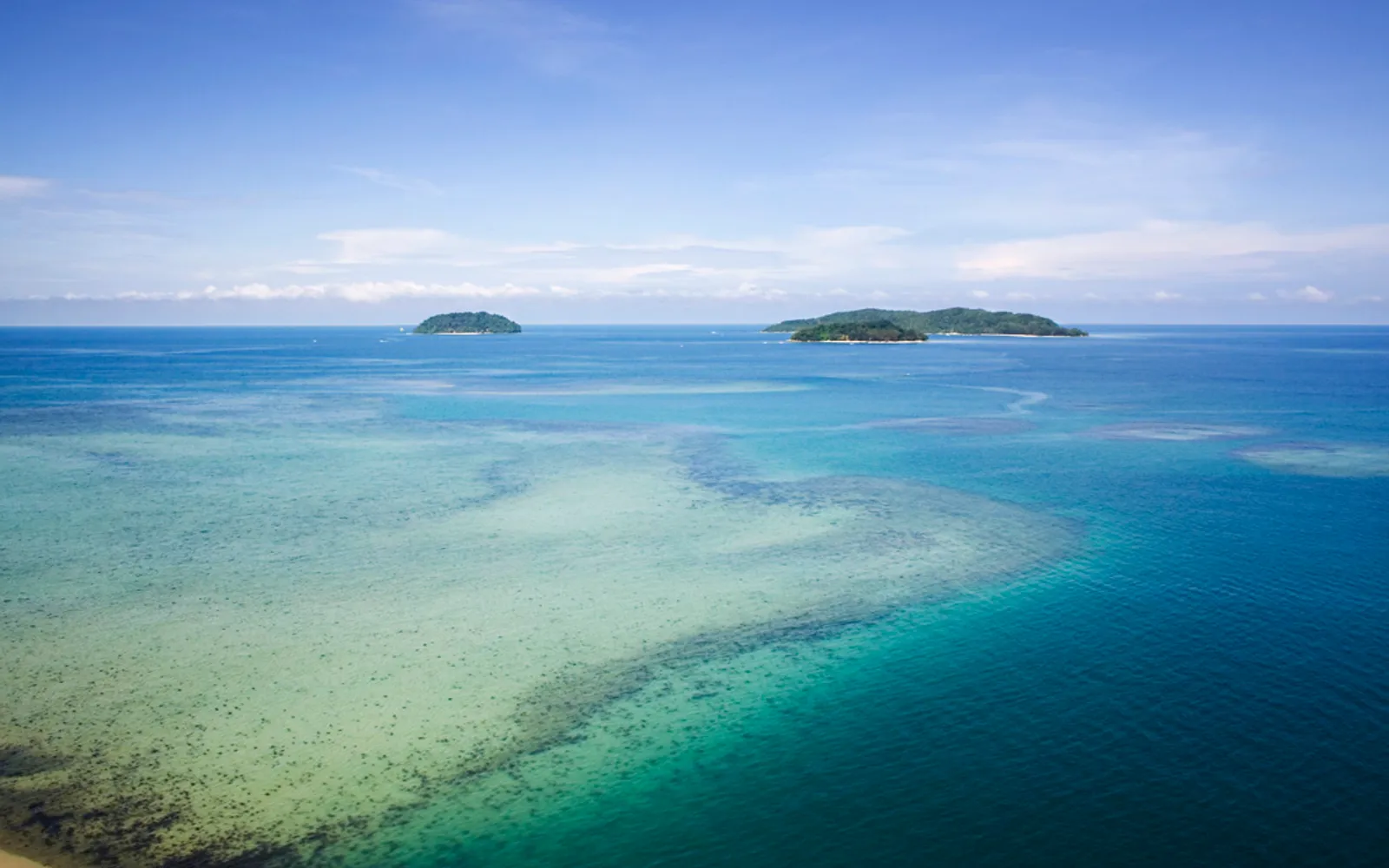 น้ำทะเลสีเขียวใสและหาดทรายขาวบนเกาะมานูกัน อุทยานทางทะเลตุนกู อับดุล ราห์มัน