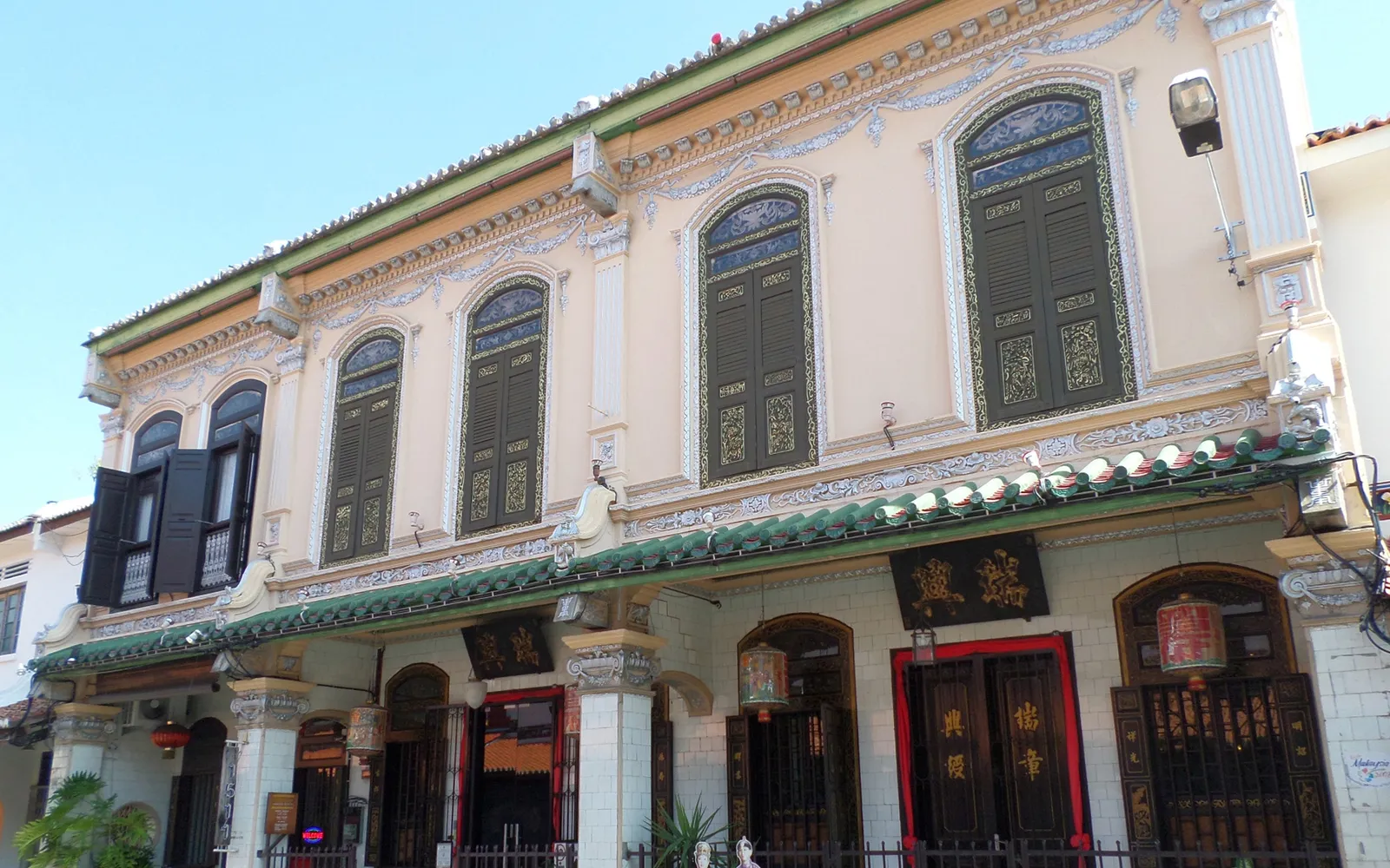 Interior of the Baba & Nyonya Heritage Museum in Melaka, displaying 19th-century Peranakan furniture and household objects