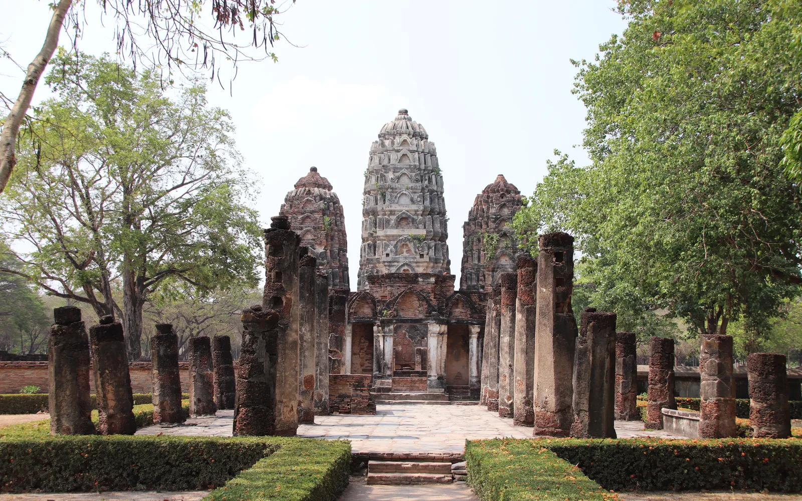 ปรางค์สามองค์เรียงกันของวัดศรีสวาย ศิลปะลพบุรีรับอิทธิพลขอม ฐานศิลาแลง ท่ามกลางต้นไม้ใหญ่