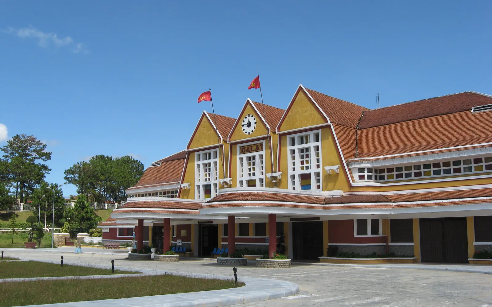 The three-peaked Art Deco roof of Da Lat Railway Station in morning light